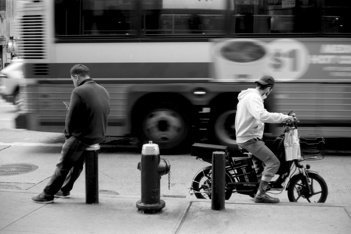 people outside with backs toward each other